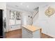 Bright eat-in kitchen with island, stainless appliances, and stair access at 5117 Singing Wind Dr, Raleigh, NC 27612
