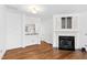 Open-concept living room with fireplace, hardwood floors, and open to dining area at 5117 Singing Wind Dr, Raleigh, NC 27612