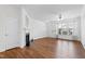 Bright living room featuring a fireplace, hardwood floors, and large windows at 5117 Singing Wind Dr, Raleigh, NC 27612
