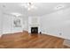 Spacious living area with hardwood floors and a cozy fireplace at 5117 Singing Wind Dr, Raleigh, NC 27612