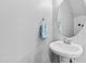 Clean powder room with pedestal sink and round mirror at 5117 Singing Wind Dr, Raleigh, NC 27612