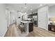 Bright kitchen with an island, stainless steel appliances, and wood floors at 5306 Beckom St, Raleigh, NC 27616