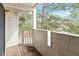 Exterior shot of outdoor balcony with wood railing, white siding and lush greenery at 600 Audubon Lake Dr # 5A32, Durham, NC 27713