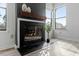 Living room fireplace with mantel and hearth, and two windows for natural light at 600 Audubon Lake Dr # 5A32, Durham, NC 27713