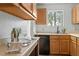 Kitchen featuring black appliances, wood cabinets, laminate counters, and hardwood floors at 600 Audubon Lake Dr # 5A32, Durham, NC 27713