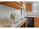 Kitchen featuring black appliances, wood cabinets, laminate counters, and hardwood floors at 600 Audubon Lake Dr # 5A32, Durham, NC 27713