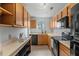 Well-equipped kitchen features wooden cabinets, black appliances, sleek countertops and hardwood floors at 600 Audubon Lake Dr # 5A32, Durham, NC 27713