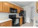 Updated kitchen with black appliances, ample countertop space and wooden cabinetry at 600 Audubon Lake Dr # 5A32, Durham, NC 27713