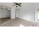 Bright living room featuring ceiling fan, light wood-look flooring, and neutral paint at 600 Audubon Lake Dr # 5A32, Durham, NC 27713