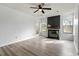 Spacious living room with a fireplace, ceiling fan, hardwood floors, and plenty of natural light at 600 Audubon Lake Dr # 5A32, Durham, NC 27713