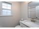 Bathroom with a single sink vanity, framed mirror and natural light from the window at 609 S Allen Rd, Wake Forest, NC 27587