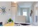 Hallway with colorful accents, fun modern clock, and closet with louvered doors at 610 Chalcedony Ct, Durham, NC 27703