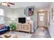 Inviting living room with a modern entertainment center, vibrant rug, and staircase access at 610 Chalcedony Ct, Durham, NC 27703