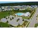 This aerial view shows the community pool, playground, clubhouse, and parking lot at 622 Ravensworth Dr, Garner, NC 27529