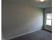 This bedroom features neutral walls, carpet flooring, and a window for natural light at 622 Ravensworth Dr, Garner, NC 27529