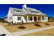 This is a beautifully landscaped building with neutral paint and a red front door at 622 Ravensworth Dr, Garner, NC 27529