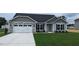Charming single-story home with stone accents, attached two car garage and manicured front yard at 622 Ravensworth Dr, Garner, NC 27529