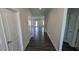 Inviting hallway with hardwood flooring, neutral paint, and doors leading to various rooms at 622 Ravensworth Dr, Garner, NC 27529