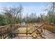 Wooden back deck offers a private outdoor space with seating and a view of the fenced backyard at 628 Bragg St, Raleigh, NC 27610