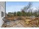 Relaxing back deck featuring wooden railings, stylish outdoor seating, and a view of the backyard at 628 Bragg St, Raleigh, NC 27610