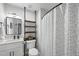 Cozy bathroom with sleek vanity, industrial shelving, and a shower-tub combo at 628 Bragg St, Raleigh, NC 27610
