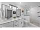 Bright bathroom featuring a double vanity, modern fixtures, and a glass-enclosed shower at 628 Bragg St, Raleigh, NC 27610