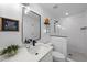Modern bathroom featuring a sleek vanity, stylish mirror, and a walk-in shower with white subway tile at 628 Bragg St, Raleigh, NC 27610