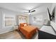 Cozy bedroom featuring a murphy bed, ceiling fan, and two windows for natural light at 628 Bragg St, Raleigh, NC 27610