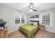 Cozy bedroom with a comfortable bed, natural light from two windows, and hardwood floors at 628 Bragg St, Raleigh, NC 27610
