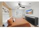 Bright bedroom with a murphy bed, modern fan, and mounted TV at 628 Bragg St, Raleigh, NC 27610