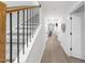 Bright hallway with wood floors, white walls, and a staircase with black railings at 628 Bragg St, Raleigh, NC 27610