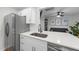 Bright kitchen featuring white cabinets, modern countertops, stainless steel appliances, and an open design to the living area at 628 Bragg St, Raleigh, NC 27610