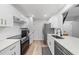 Contemporary kitchen with white cabinetry, stainless steel appliances, and stylish hardware at 628 Bragg St, Raleigh, NC 27610