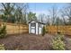 Storage shed in the fenced backyard adds functionality and enhances the property's appeal at 628 Bragg St, Raleigh, NC 27610
