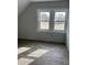 Well-lit bedroom featuring two windows and new flooring at 728 East Ave, Henderson, NC 27536