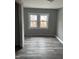 Bedroom featuring two windows and new flooring at 728 East Ave, Henderson, NC 27536