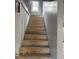 Wooden staircase featuring unfinished walls and a window at 728 East Ave, Henderson, NC 27536