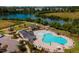 Aerial view of the community pool, clubhouse, and amenities with a beautiful lake in the background at 810 Hillfarm Dr, Wake Forest, NC 27587