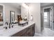 Modern bathroom with double vanity, dark wood cabinets, and marble-look tile at 810 Hillfarm Dr, Wake Forest, NC 27587