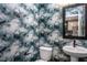 Stylish powder room with patterned wallpaper, a modern vanity, and a sleek mirror, creating a chic and functional space at 810 Hyperion Aly, Wake Forest, NC 27587