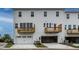 Rear exterior of townhomes with garages and small balconies at 810 Hyperion Aly, Wake Forest, NC 27587