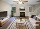 Bright living room features a fireplace, ceiling fan, and contemporary furnishings at 859 Dalewood Dr, Raleigh, NC 27610