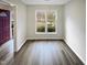 Bright living room with wood floors, neutral paint, and a double window at 859 Dalewood Dr, Raleigh, NC 27610