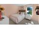 Comfortable bedroom with a colorful striped bedspread and bright natural light at 86 Saddle Mare St, Clayton, NC 27520