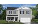 Charming two-story home with gray siding, black shutters, covered entry, and two-car garage at 86 Saddle Mare St, Clayton, NC 27520