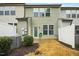 A serene backyard view with lush shrubs enhancing the home's exterior, near a white fence at 94 E Grove Point Dr, Clayton, NC 27527