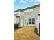 A backyard featuring an outdoor patio, with a door, surrounded by grass and a fence at 94 E Grove Point Dr, Clayton, NC 27527