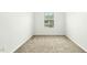 Small empty bedroom featuring carpeted floors and a window at 94 E Grove Point Dr, Clayton, NC 27527