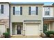 Well maintained townhome with black shutters, a garage, and tasteful landscaping at 94 E Grove Point Dr, Clayton, NC 27527