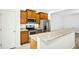 The kitchen has stainless steel appliances, light countertops, and wood cabinets at 94 E Grove Point Dr, Clayton, NC 27527